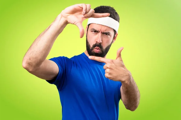 Αστεία αθλητή εστιάζοντας πολύχρωμο φόντο με τα δάχτυλά του — Φωτογραφία Αρχείου