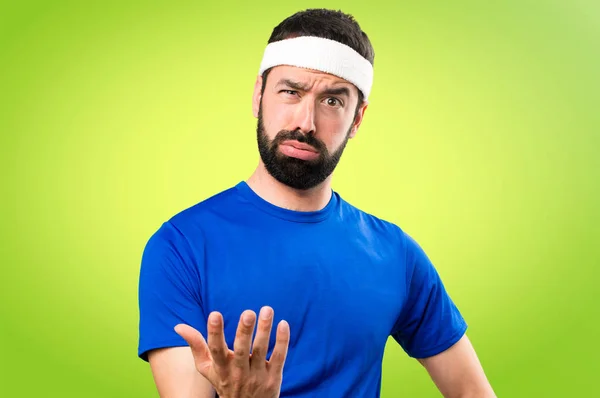 Tired funny sportsman on colorful background — Stock Photo, Image
