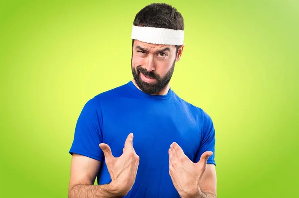 Funny sportsman making surprise gesture on colorful background — Stock Photo, Image