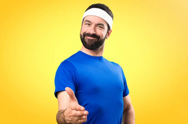 Funny sportsman making a deal on colorful background — Stock Photo, Image