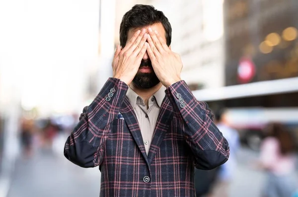 Dobře oblečený muž si zakryl oči ve městě — Stock fotografie