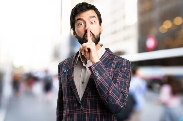 Well dressed man making silence gesture in the city — Stock Photo, Image