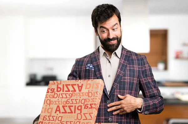 Goed geklede man houden van pizza's in huis — Stockfoto