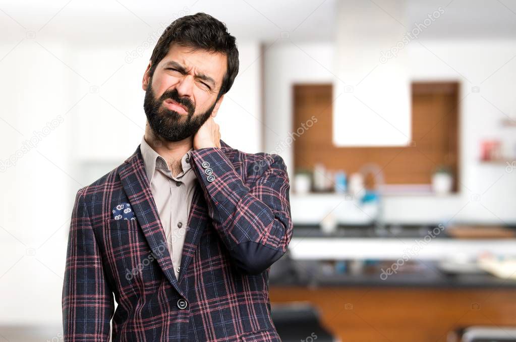 Well dressed man with neck pain inside house