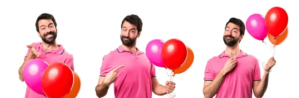 Σύνολο όμορφος νεαρός άνδρας κρατά μπαλόνια — Φωτογραφία Αρχείου
