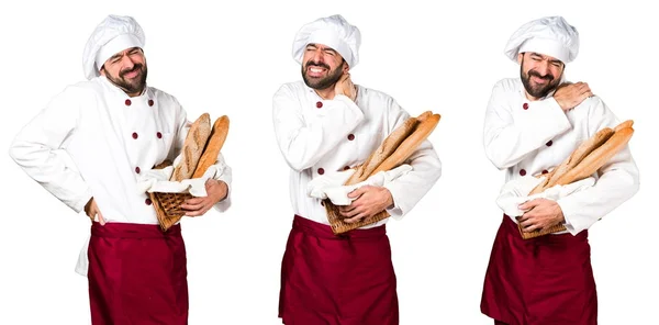 Jonge baker houden wat brood met nekpijn — Stockfoto