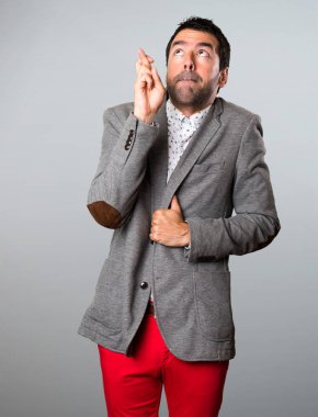 Gri arka plan üzerinde geçiş parmaklarıyla yakışıklı adam