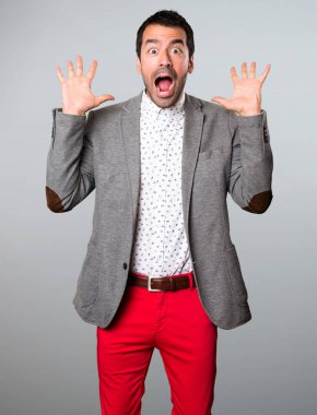 Yakışıklı adam yapma sürpriz jest gri arka plan üzerinde