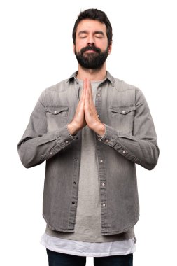 Beyaz arka plan üzerinde zen pozisyonda sakallı yakışıklı adam