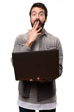 Beyaz adam üstünde laptop ile sakallı sürpriz yakışıklı adam