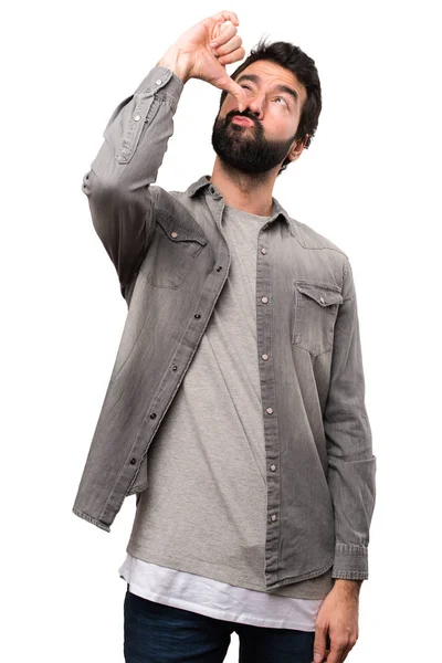 Schöner Mann mit Bart macht betrunkene Geste auf weißem Hintergrund — Stockfoto