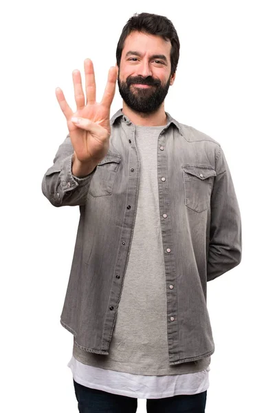 Knappe man met baard tellen vier op witte achtergrond — Stockfoto