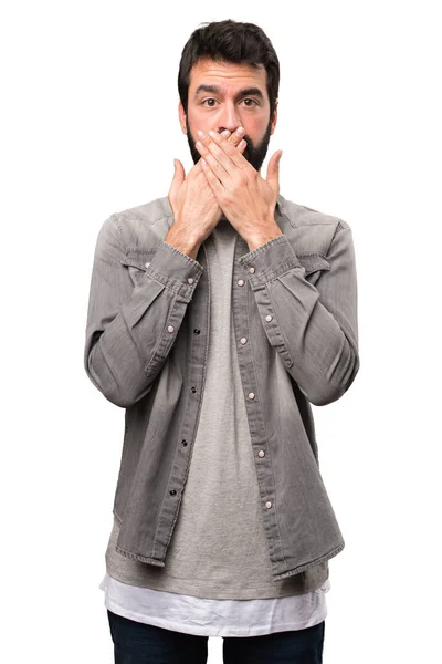 Handsome man with beard covering his mouth on white background — Stock Photo, Image