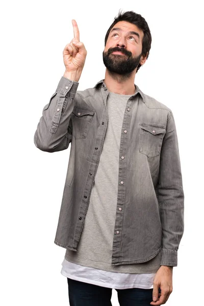 Handsome man with beard pointing up on white background — Stock Photo, Image