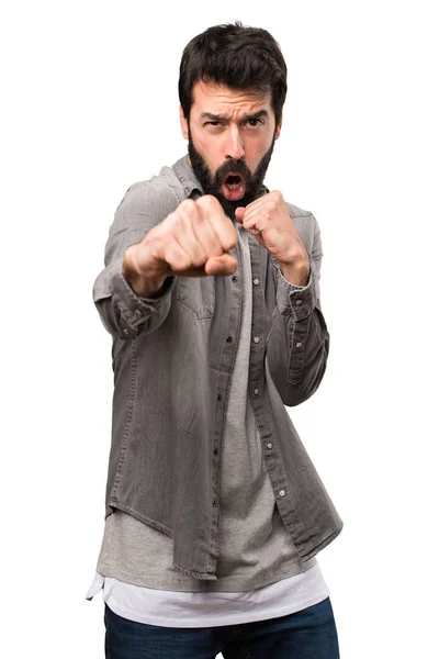 Bonito homem com barba lutando no fundo branco — Fotografia de Stock