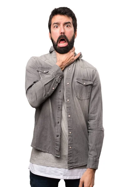 Bonito homem com barba se afogando em fundo branco — Fotografia de Stock