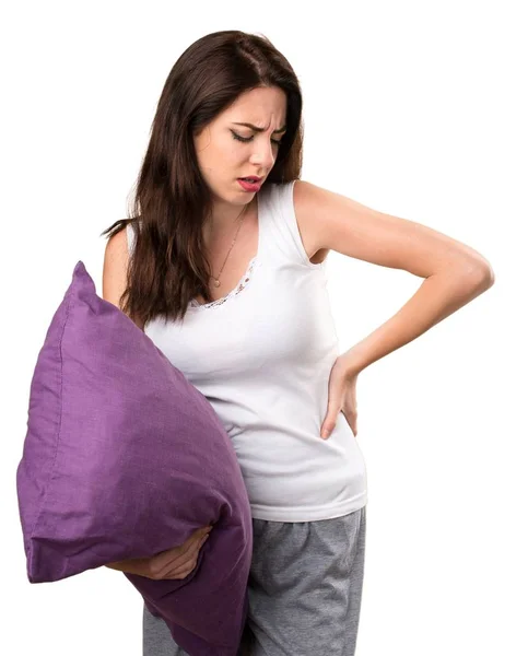 Красива молода дівчина з подушкою з болем у спині — стокове фото