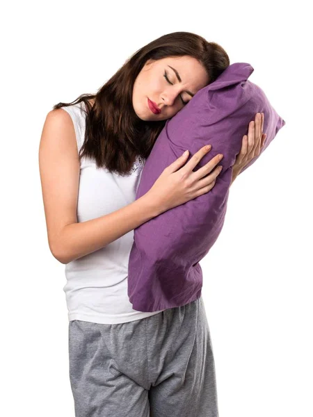 Bella ragazza con un cuscino fare gesto del sonno — Foto Stock