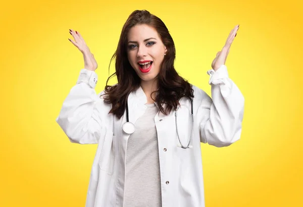 Läkare kvinna gör överraskning gest på gul bakgrund — Stockfoto