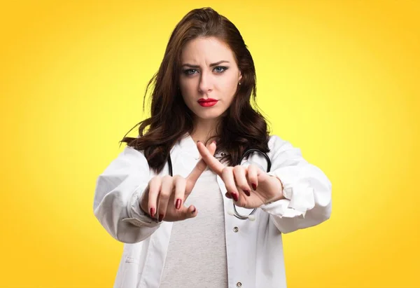 Doktor žena dělat žádné gesto na žlutém podkladu — Stock fotografie