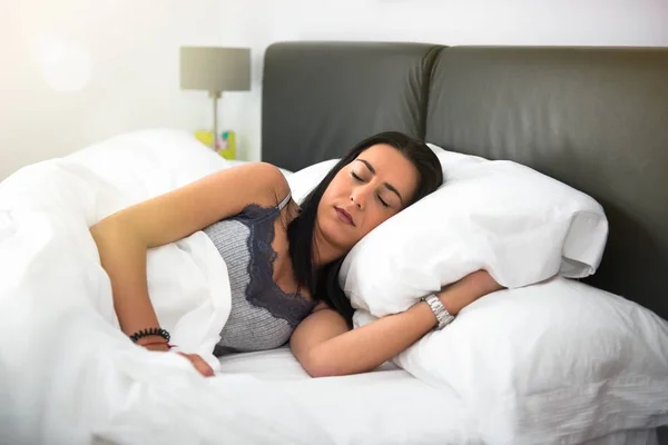 Beautiful young girl sleeping in her bed