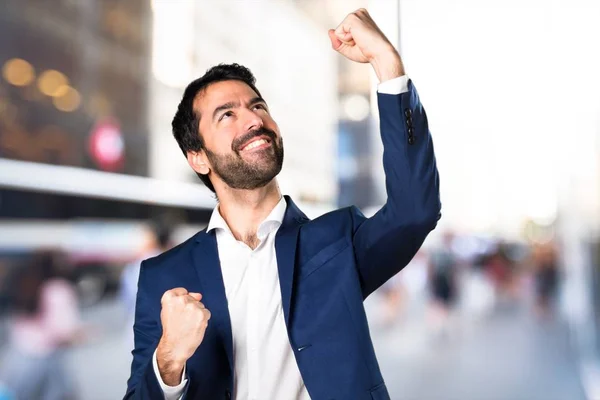 Lucky handsome man on unfocused background — Stock Photo, Image