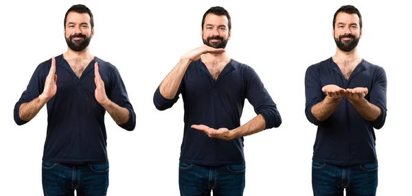 Conjunto de hombre guapo con barba sosteniendo algo — Foto de Stock