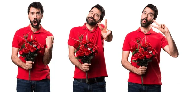 Conjunto de hombre guapo sosteniendo flores haciendo gesto de victoria —  Fotos de Stock