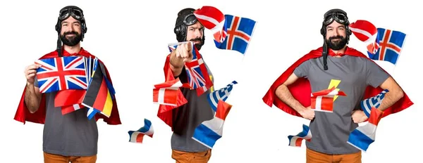 Superhero with a lot of flags pointing to the front — Stock Photo, Image