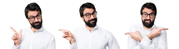Handsome man with glasses pointing to the lateral — Stock Photo, Image