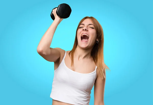Beautiful sport woman with dumbbells shouting on colorful backgr — Stock Photo, Image