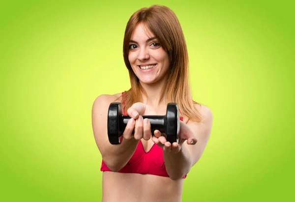 Happy beautiful sport woman with dumbbells on colorful backgroun — Stock Photo, Image