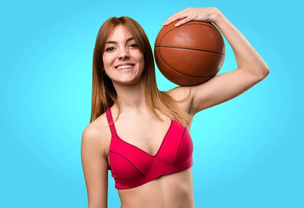 Jovem mulher esporte com bola de basquete no fundo colorido — Fotografia de Stock