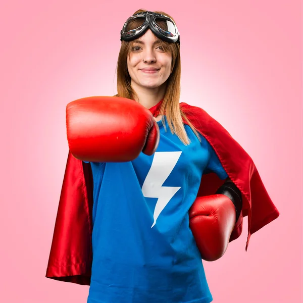 Superhero girl with boxing gloves on colorful background