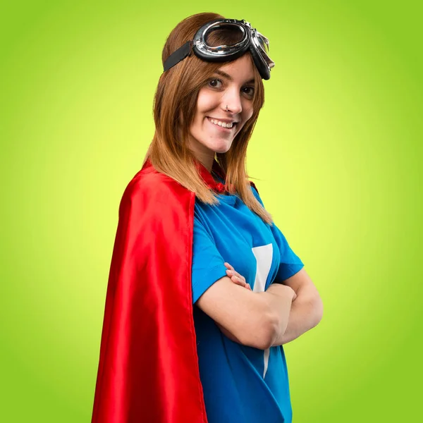 Pretty superhero girl with her arms crossed on colorful backgrou — Stock Photo, Image