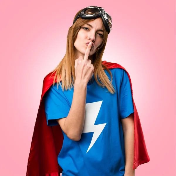 Pretty superhero girl making horn and kiss gesture on colorful b