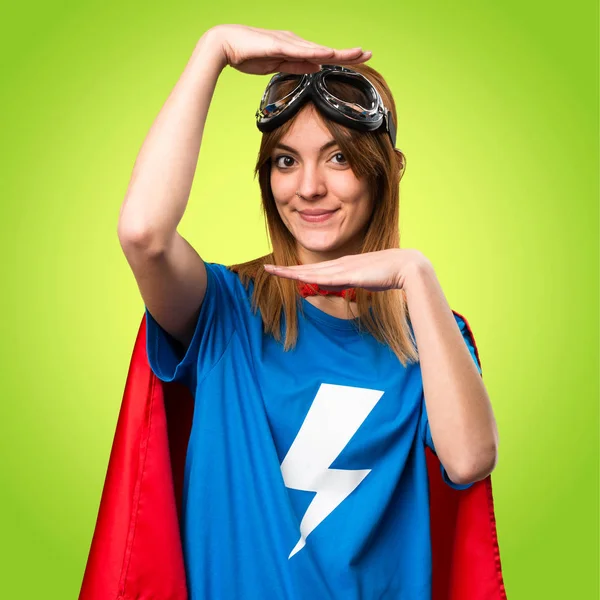 Pretty superhero girl focusing her face on colorful background