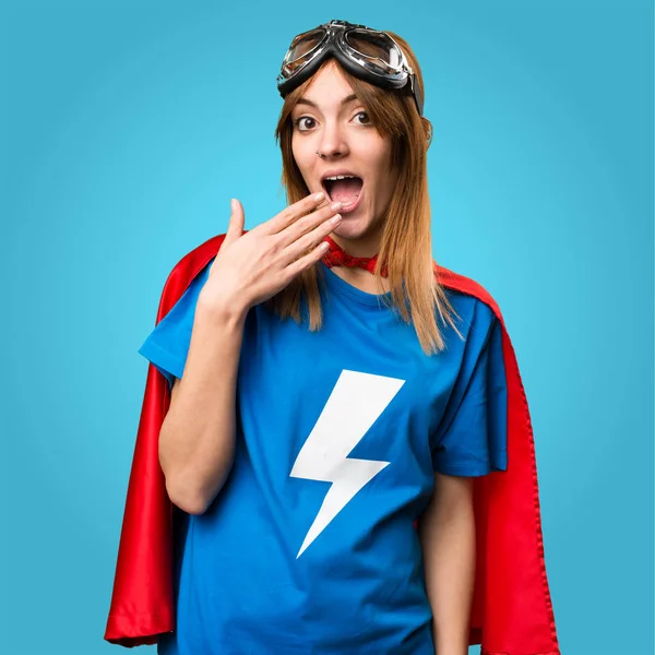 Hezká superhrdina dívka dělat překvapení gesto na barevné pozadí — Stock fotografie