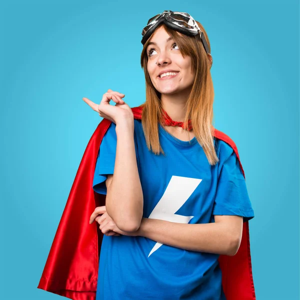 Pretty superhero girl thinking on colorful background