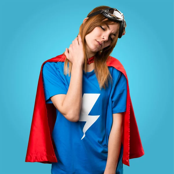 Pretty superhero girl with neck pain on colorful background