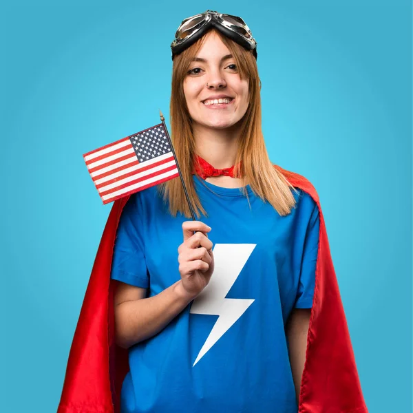 Bastante chica superhéroe sosteniendo una bandera americana en backg colorido —  Fotos de Stock