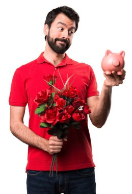 Yakışıklı adam beyaz arka plan üzerinde bir servet tutan çiçek tutan