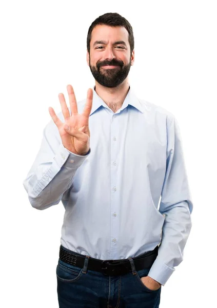 Homem bonito com barba contando quatro — Fotografia de Stock