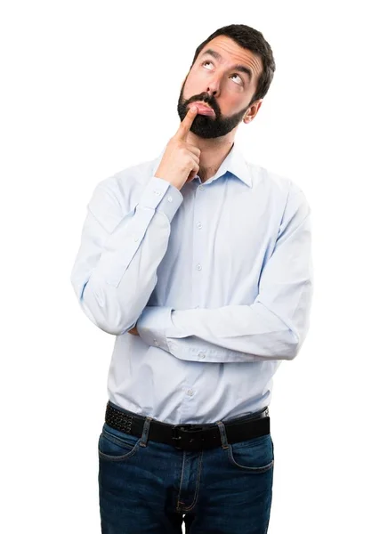 Bonito homem com barba tendo dúvidas — Fotografia de Stock