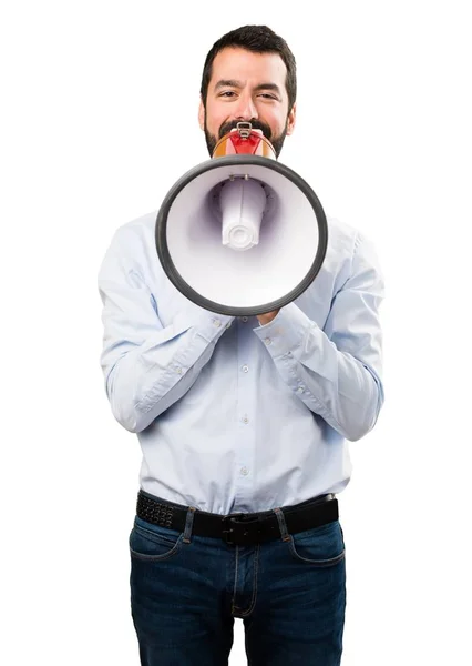 Hombre guapo con barba sosteniendo un megáfono — Foto de Stock