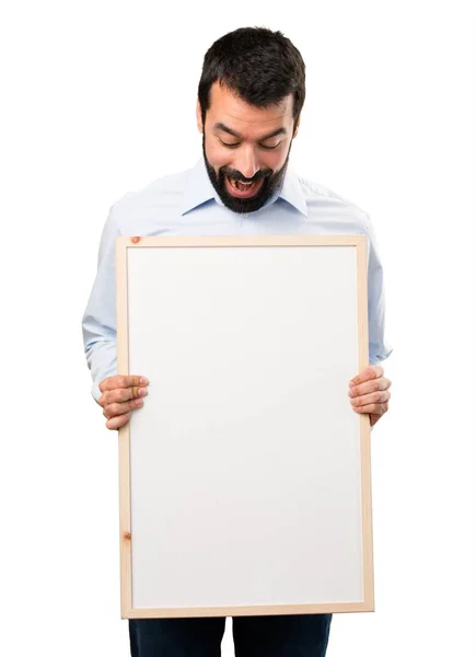 Surprised Handsome man with beard holding an empty placard — Stock Photo, Image