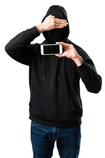 Hacker z jego telefon komórkowy, ukrywszy twarz na na białym tle liczby biały — Zdjęcie stockowe