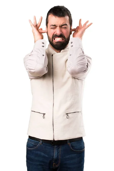 Bonito homem com colete cobrindo seus ouvidos em fundo branco isolado — Fotografia de Stock