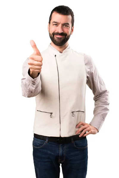 Bonito homem com colete com polegar para cima em fundo branco isolado — Fotografia de Stock