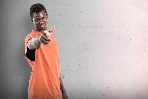 Handsome black man pointing to the front on textured background